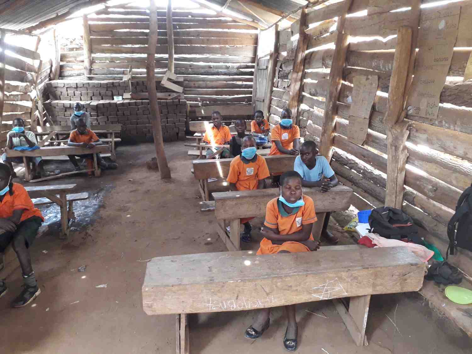 Happy Ugandan children with school supplies